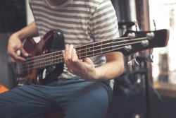 Man play on bass guitar