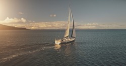 Aerial yacht regatta race at open sea. White sail boat at summer sunlight day. Amazing seascape of ocean waters at sun reflections. Serene water at cinematic relax and calm waterscape