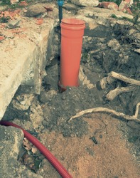 Safety tube with cables. Reconstruction site with trench for underground telephone optical lines