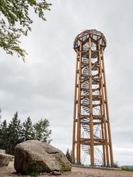 Wooden and steel  lookout tower called Svetly Vrch. Hiking at Albrechtice in Jizerske mountains, Czechia. Original watch tower overlooks summer cloudy countryside, active life