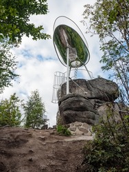 High view tower in design of comic speech bubble in the forest, low angle shot. Interesting lookout tower Spicka, a viewing platform in the design of a spaceship