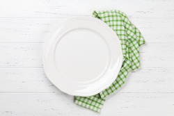Empty plate on wooden table. Top view with space for your meal