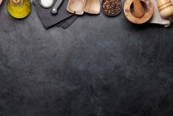 Cooking utensils and spices on stone kitchen table. Top view with copy space for your recipe