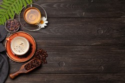 Herbal tea and espresso coffee on wooden table. Top view with copy space. Flat lay