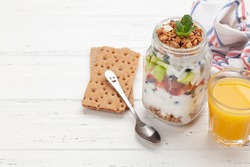 Healthy breakfast with jar of granola, yogurt and fresh berries. Fitness protein meal and diet concept. With copy space