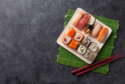 Set of sushi and maki roll on stone table. Top view with copy space