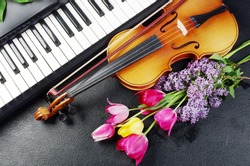 Piano keyboard, violin, bouquet of flowers.
