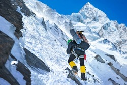 Climber reaches the summit of Himalayas mountains. National Park, Nepal.