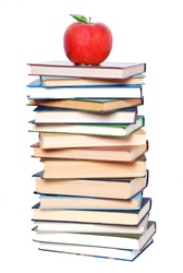 School and Education. Books tower with apple isolated on white