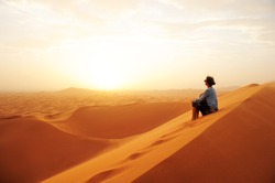 Sand dunes in the Sahara desert. Girl  between sand dunes. Lands