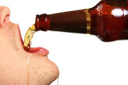 pouring beer into the mouth from bottle