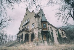Old abandoned mansion in mystic spooky forest