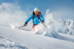 Male freeride skier in the mountains