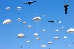 C-130 Hercules planes drop paratroopers