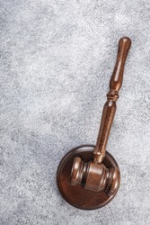 Judge's wooden gavel on grey background, vertical. Law concept