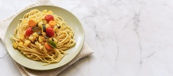 Spaghetti with vegetables with copy space for text