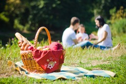 Picnic Basket with apples and bread. Family disfocused