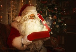 Santa Claus inside a home, portrait with presents