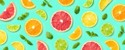 Colorful pattern of citrus fruit slices and mint leaves on blue background. Top view, flat lay
