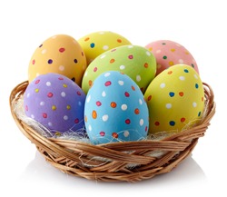 Basket of colorful Easter eggs isolated on white background