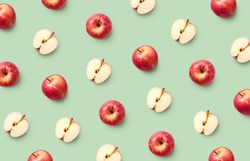Colorful fruit pattern of fresh red apples on light green background