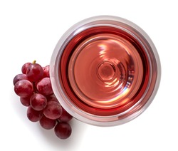 Glass of rose wine and grapes isolated on white background from top view