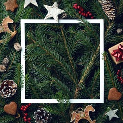 Creative frame of Christmas tree branches and decorations with space for text. Top view. Xmas and New year concept