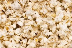Scattered salted popcorn, texture background. Close up.The view from the top.