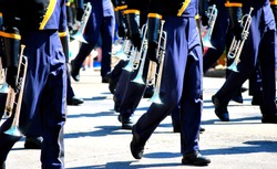 Marching band performing with the trumpet section highlighted.