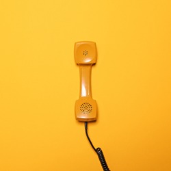 Retro yellow telephone tube on yellow background - Flat lay
