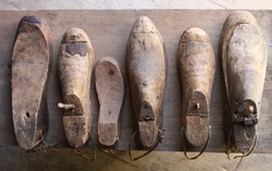 Rustic wooden shoe lasts on wooden surface
