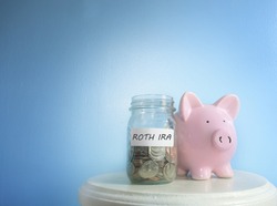 Roth IRA savings jar and piggy bank