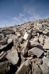 Tilted vertical image of pile of concrete debris.