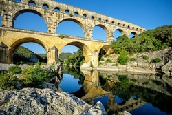 The three-tiered Pont du Gard aqueduct preserved from the time of the Roman Empire on the Gardon river near Avignon, Provence, France