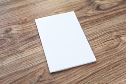Blank of brochure is on a wooden desk. Template for your design. 