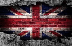 Broken grunge wall with British flag on old brick wall behind.