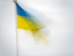Ukraine national flag blowing in the wind. Defocused Impressionist effect with copyspace.