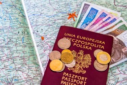 Red passports and money (polish zloty and dollars) over map background