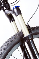 Mountain bike wheel with suspension fork on white background
