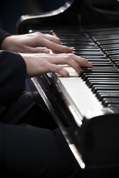 Pianist playing piano outdoors