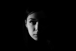 Beautiful woman face in the darkness