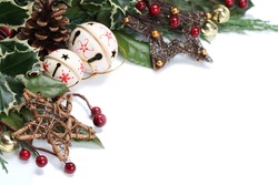 Christmas border with jingle bells, stars and other Christmas ornaments and decorations isolated on white. Shallow dof