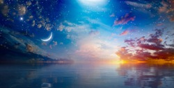 Amazing surreal background - crescent moon rising above serene sea in sunset sky, glowing horizon and bright stars.  Elements of this image furnished by NASA