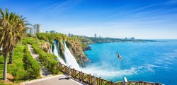 Aerial panoramic image of Lower Duden waterfall in Antalya, Turkey. Water falls drop off rocky cliff directly into Mediterranean sea in sunny summer day.