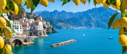 Panoramic view of small town Atrani on Amalfi Coast in province of Salerno, Campania region, Italy. Amalfi coast is popular travel and holyday destination in Italy. Ripe yellow lemons in foreground.
