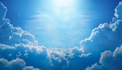Beautiful religious image with Jesus Christ in blue sky with clouds, bright light from heaven. Jesus rose from dead and ascended into heaven