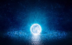 Full moon party concept image. Luminous sphere, similar to full moon, levitates over water. Elements of this image furnished by NASA