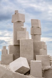 Blocks of compacted white sand arranged on beach site in preparation for sculptors to begin work in a competitive sand sculpting festival on a cloudy day in November along the Gulf Coast of Florida