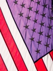 Rear view of American flag flying in daylight, for motifs of reversal, eccentricity and the unconventional
