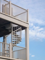 Spiral staircase between balconies on exterior corner of a multistory beach house on a barrier island along the Gulf Coast of the Florida Panhandle